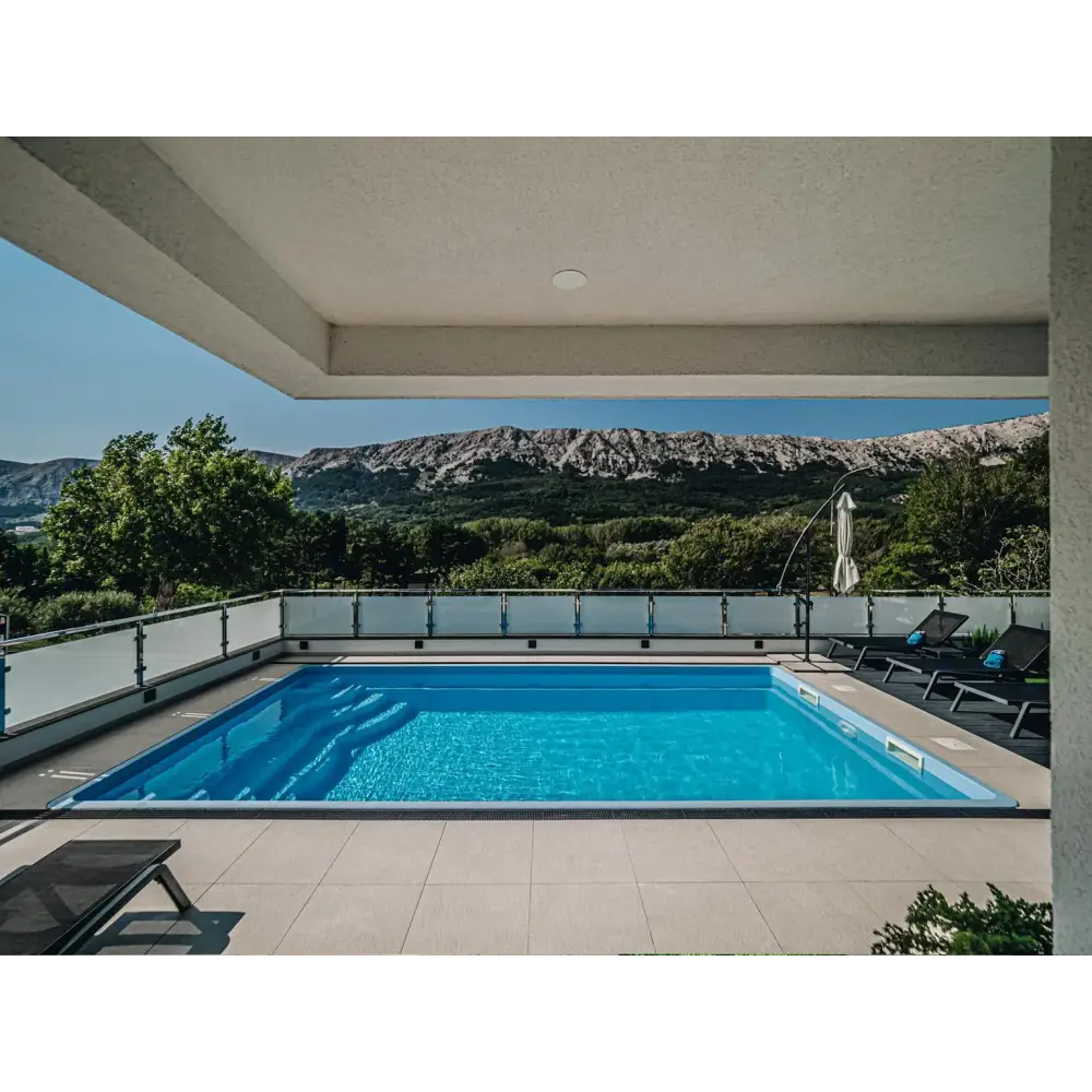 Blå rektangulär glasfiberpool Aruba med kaklad omgivning