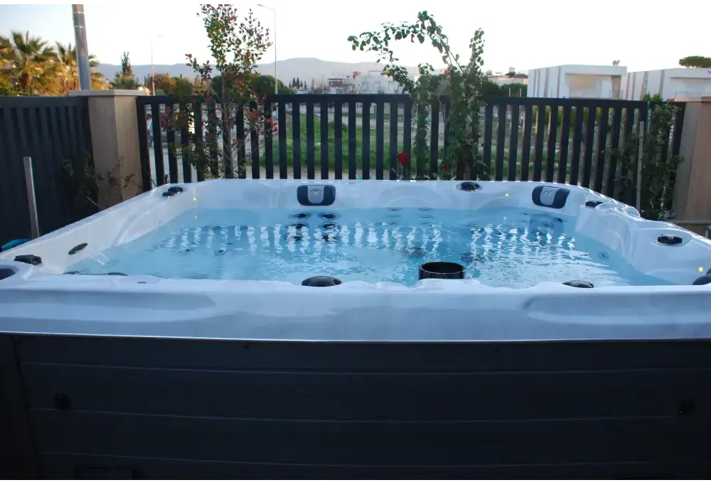 PassionSpa Desire Whirlpool – weiß und grau, blaues Wasser, schwarze Massagedüsen