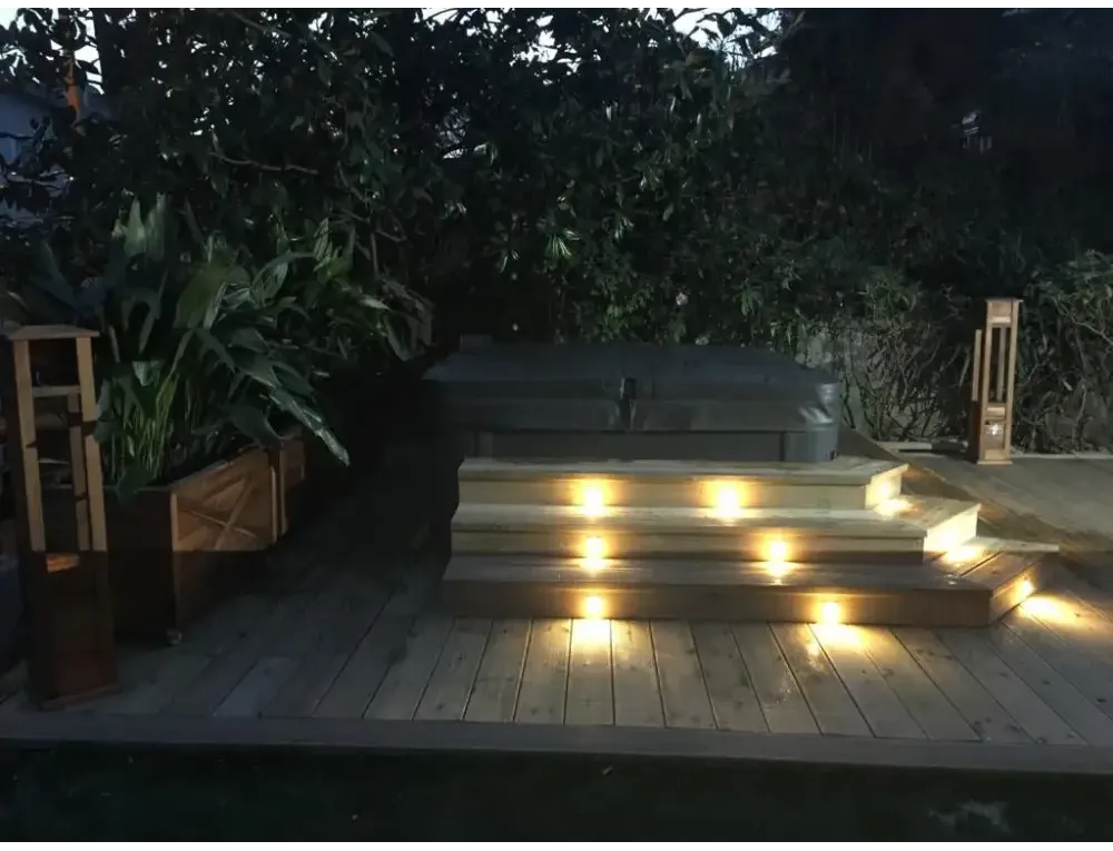 PassionSpa Relax Whirlpool – Pure Collection, dunkelgraue Oberfläche, Holztreppe, stimmungsvolle Beleuchtung