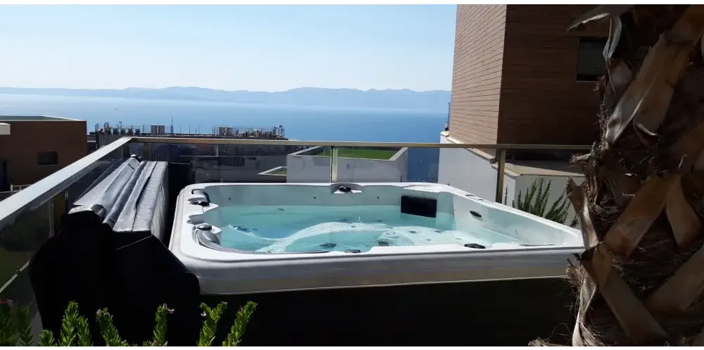 PassionSpa Relax Whirlpool – Pure Collection, weiße Ausführung, rechteckige Form, blaues Wasser, schwarze Paneele