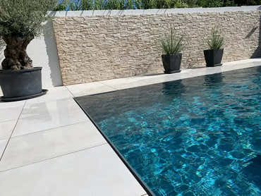 Pooltime Exclusive Overflow Pool – hellgrau gefliester Rand, türkisfarbenes Wasser
